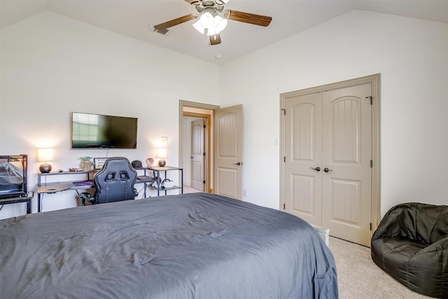 bedroom with a closet, a ceiling fan, light carpet, and lofted ceiling