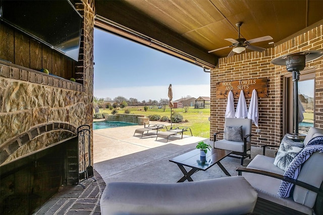 view of patio / terrace featuring outdoor lounge area, a ceiling fan, and an outdoor pool