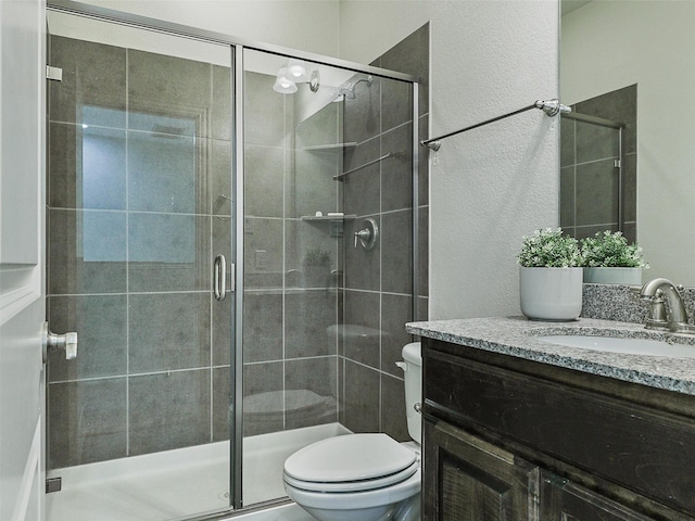 full bath featuring a shower stall, toilet, and vanity