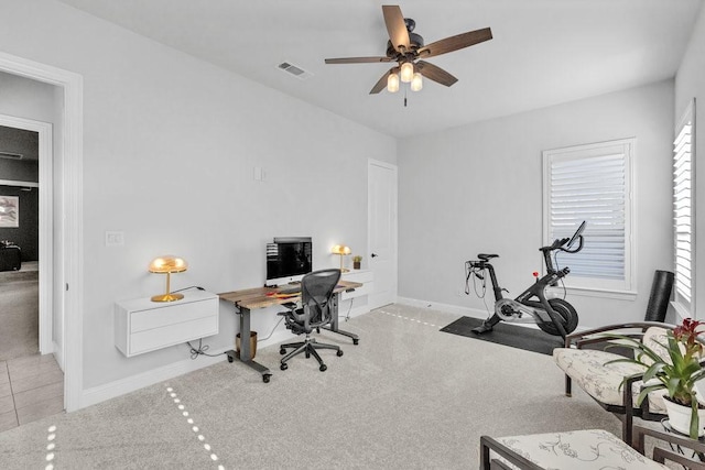 carpeted office space with visible vents, a ceiling fan, and baseboards