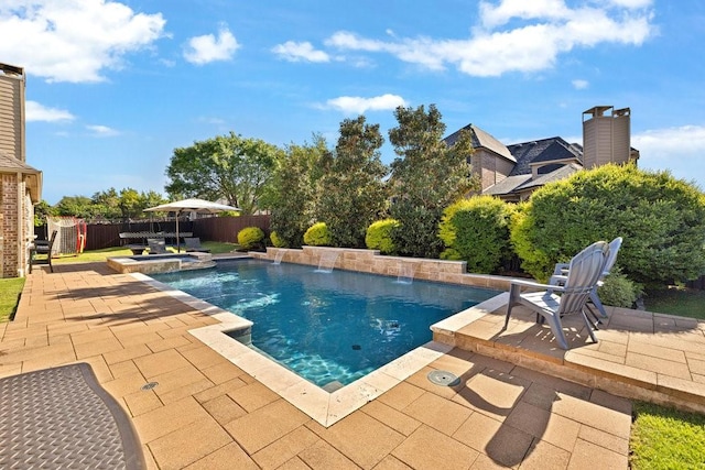 view of pool featuring a pool with connected hot tub, a fenced backyard, and a patio area