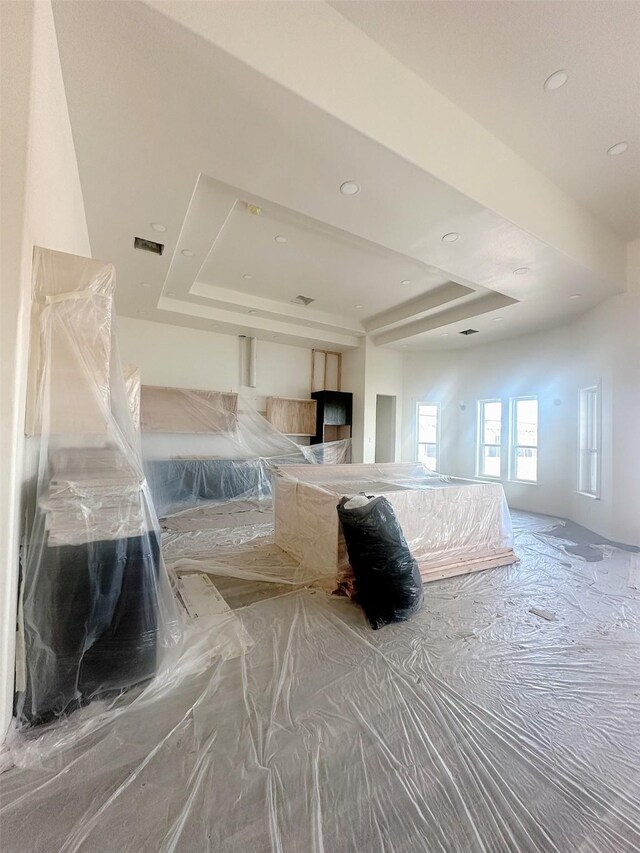 bedroom featuring recessed lighting and a raised ceiling