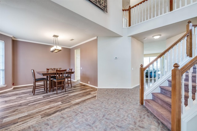 11050 Millvale Ct, Frisco, TX 75035 - staircase featuring ceiling fan, carpet floors, baseboards, a towering ceiling, and tile patterned flooring
