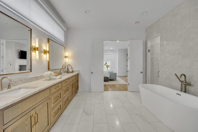 7141 Lyre Ln, Dallas, TX 75214 - ensuite bathroom featuring a soaking tub, double vanity, recessed lighting, and a shower with door