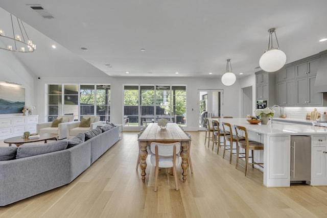 7141 Lyre Ln, Dallas, TX 75214 - living room with light wood-type flooring, recessed lighting, and a chandelier