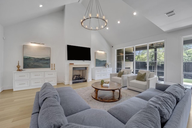 7141 Lyre Ln, Dallas, TX 75214 - living area featuring high vaulted ceiling, a chandelier, light wood finished floors, recessed lighting, and baseboards