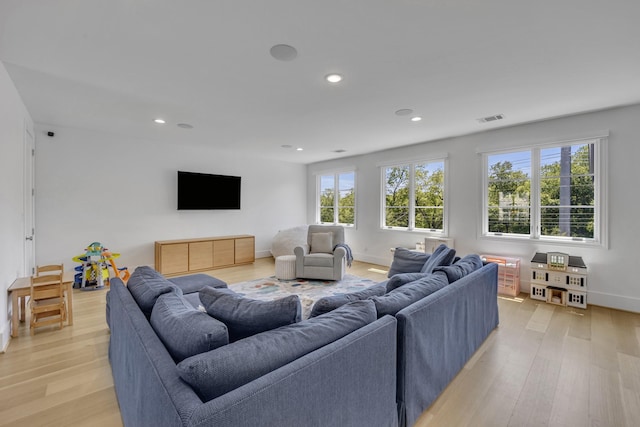 living area with recessed lighting, visible vents, baseboards, and light wood-style floors