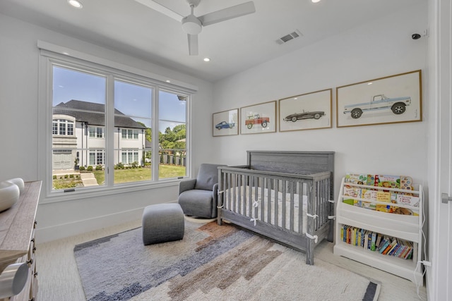 bedroom featuring recessed lighting, carpet floors, a nursery area, baseboards, and visible vents