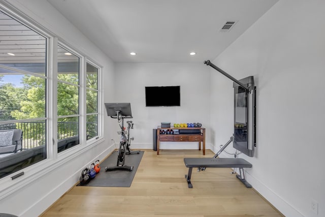 exercise area with recessed lighting, visible vents, wood finished floors, and baseboards