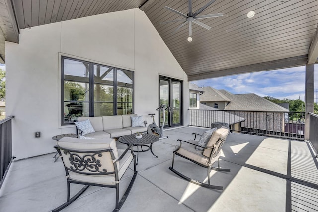 view of patio with outdoor lounge area, a ceiling fan, and a balcony