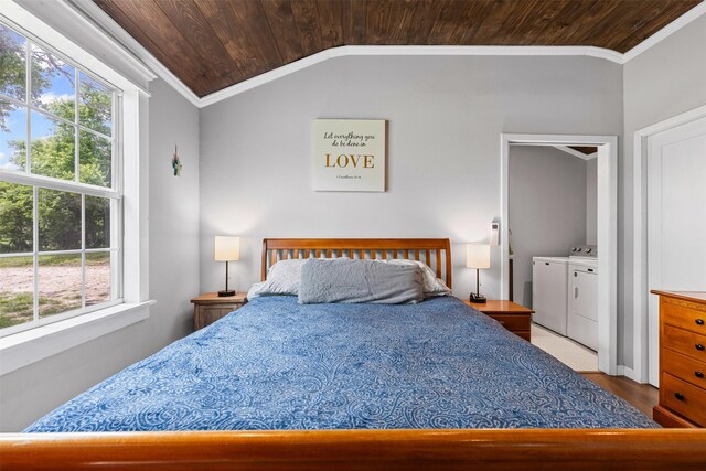 bedroom featuring wood ceiling, multiple windows, vaulted ceiling, and independent washer and dryer