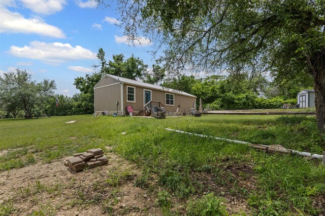 view of yard with an outbuilding and a shed