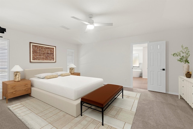 bedroom with connected bathroom, ceiling fan, visible vents, light carpet, and baseboards