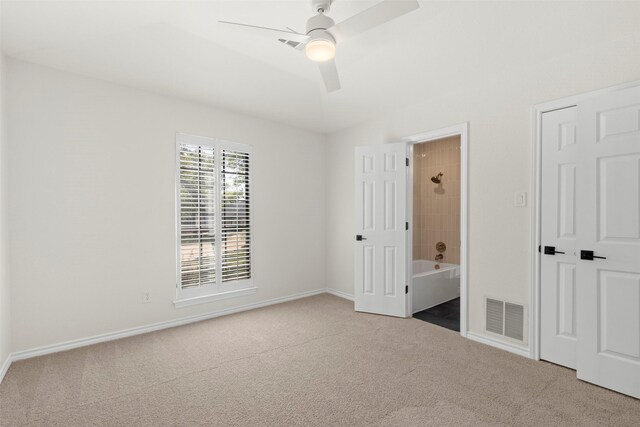 unfurnished bedroom with baseboards, visible vents, ensuite bath, and carpet floors