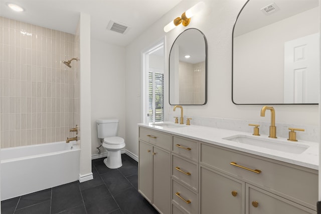 full bathroom with tile patterned floors, toilet, double vanity, and a sink