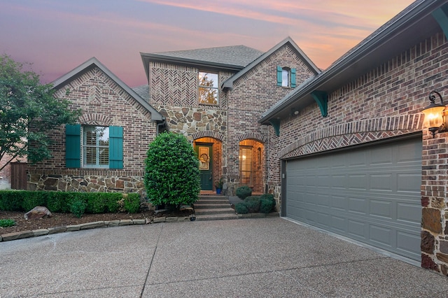 905 Maybach Ct, Mckinney, TX 75071 - french country style house with stone siding, concrete driveway, and brick siding