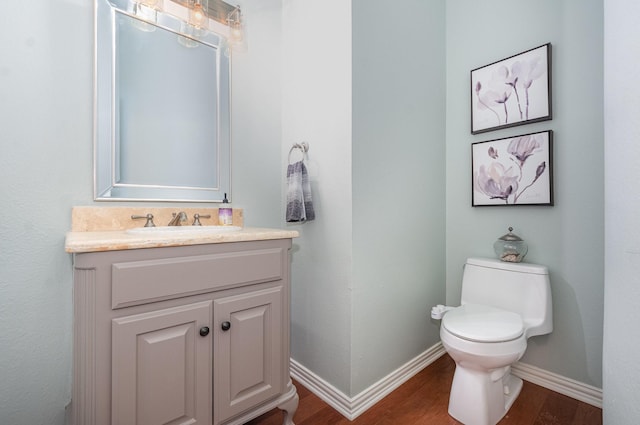 905 Maybach Ct, Mckinney, TX 75071 - half bathroom featuring toilet, baseboards, vanity, and wood finished floors