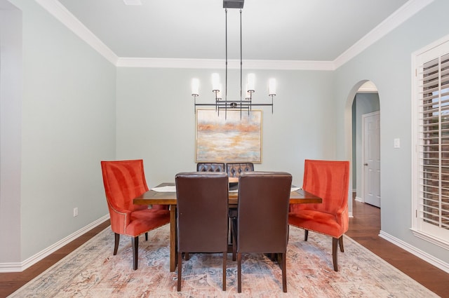 905 Maybach Ct, Mckinney, TX 75071 - dining room with arched walkways, a notable chandelier, ornamental molding, and wood finished floors