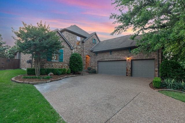 905 Maybach Ct, Mckinney, TX 75071 - view of front of house with roof with shingles, a yard, concrete driveway, and stone siding