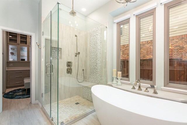 905 Maybach Ct, Mckinney, TX 75071 - full bath featuring a freestanding bath, a shower stall, and wood finished floors