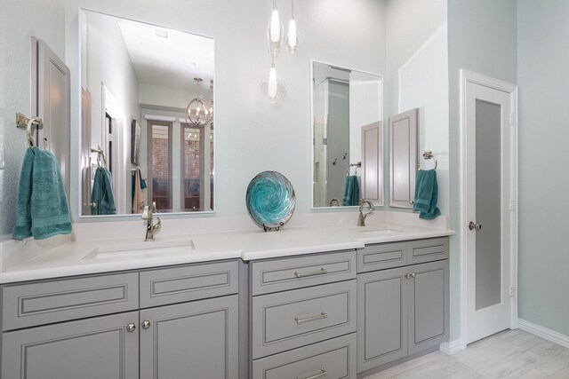 905 Maybach Ct, Mckinney, TX 75071 - bathroom featuring a sink, double vanity, and a chandelier