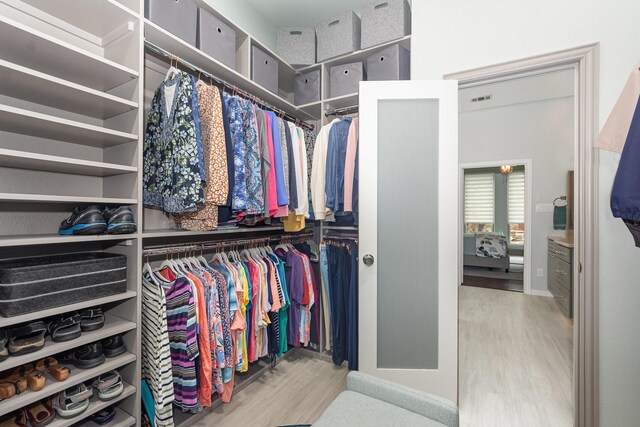 905 Maybach Ct, Mckinney, TX 75071 - walk in closet with wood finished floors and visible vents