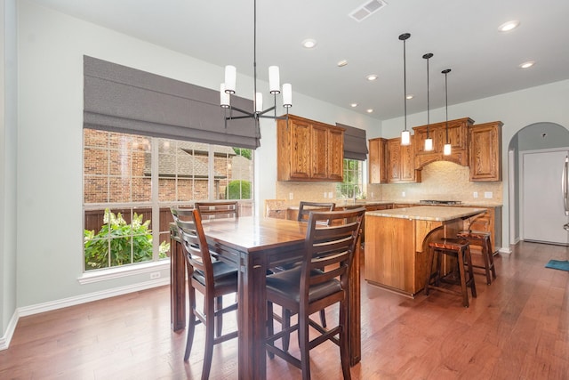 905 Maybach Ct, Mckinney, TX 75071 - dining space with visible vents, wood finished floors, arched walkways, and recessed lighting
