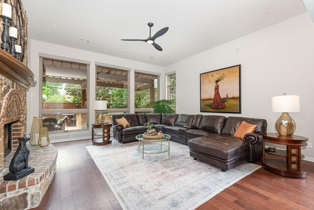 905 Maybach Ct, Mckinney, TX 75071 - living area with a brick fireplace, a ceiling fan, visible vents, and wood finished floors