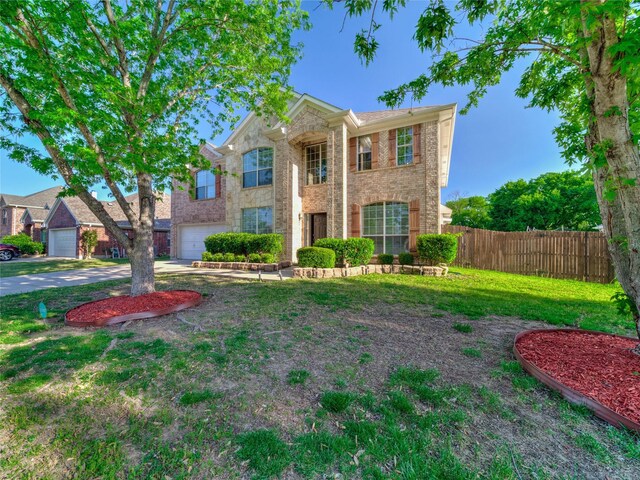 3115 Reagenea Dr, Wylie, TX 75098 - view of front of house featuring concrete driveway, brick siding, fence, and a front lawn