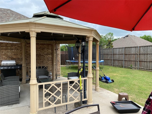 3115 Reagenea Dr, Wylie, TX 75098 - view of patio featuring area for grilling, a gazebo, a fenced backyard, and a trampoline