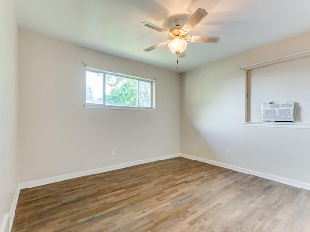 empty room featuring a ceiling fan, wood finished floors, and baseboards