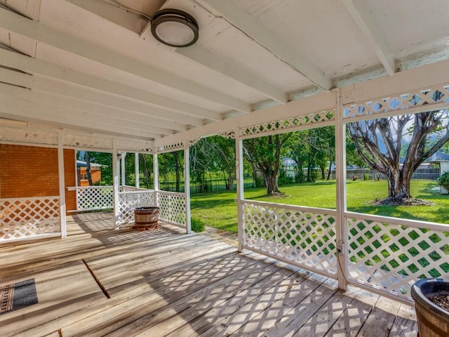 wooden terrace with a lawn