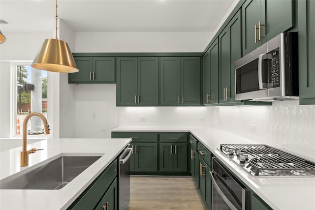 921 Janwood, Plano, TX 75075 - kitchen with green cabinets, appliances with stainless steel finishes, a sink, tasteful backsplash, and light countertops