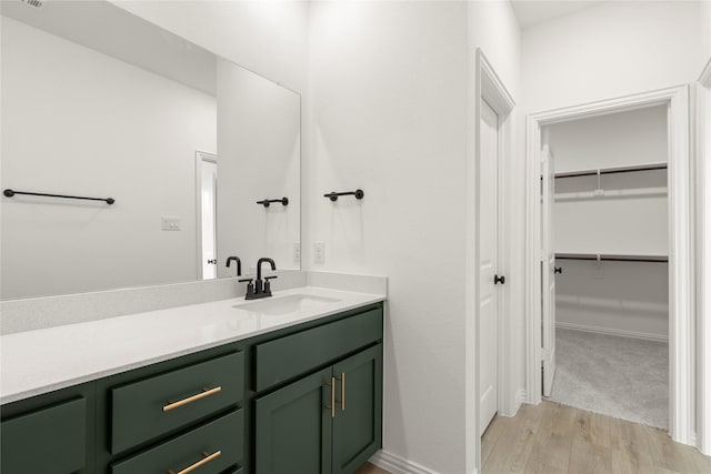 921 Janwood, Plano, TX 75075 - bathroom featuring wood finished floors, vanity, and a spacious closet