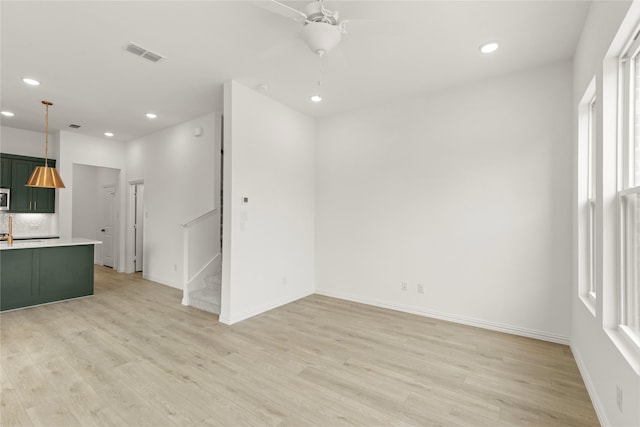 921 Janwood, Plano, TX 75075 - unfurnished living room with recessed lighting, light wood-style floors, stairs, a ceiling fan, and baseboards