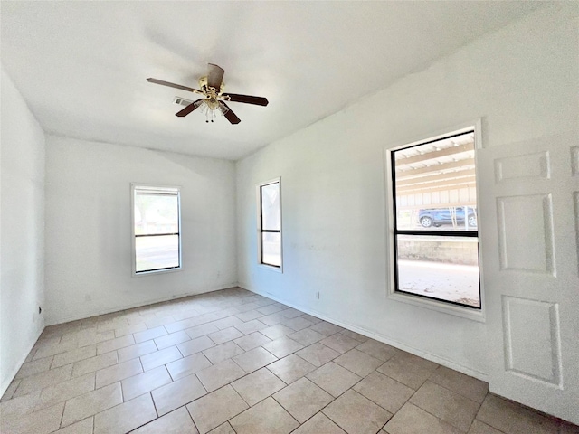 empty room with light tile patterned flooring and a ceiling fan