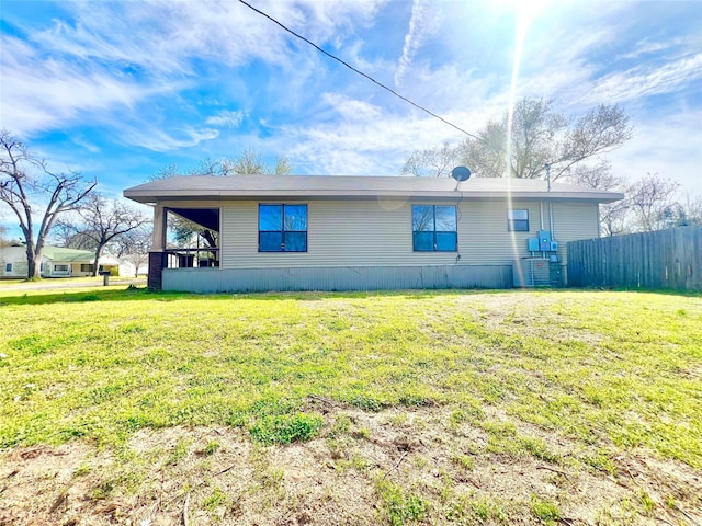 view of property exterior with a yard and fence