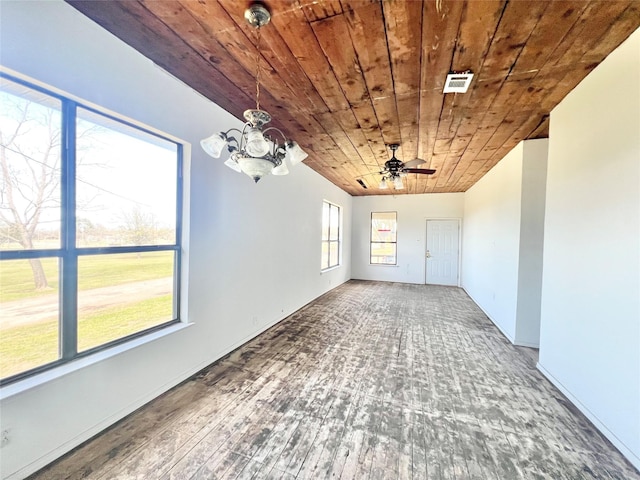 empty room with wood ceiling, wood finished floors, visible vents, and ceiling fan with notable chandelier