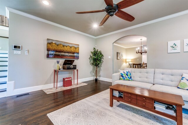 living area with recessed lighting, arched walkways, wood finished floors, ornamental molding, and baseboards