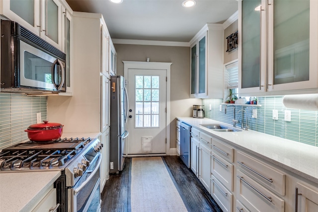 kitchen with dark wood finished floors, recessed lighting, stainless steel appliances, white cabinets, and a sink