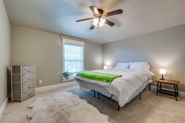 bedroom with a ceiling fan, carpet flooring, and baseboards