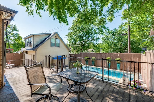 deck with cooling unit, a fenced backyard, and a fenced in pool