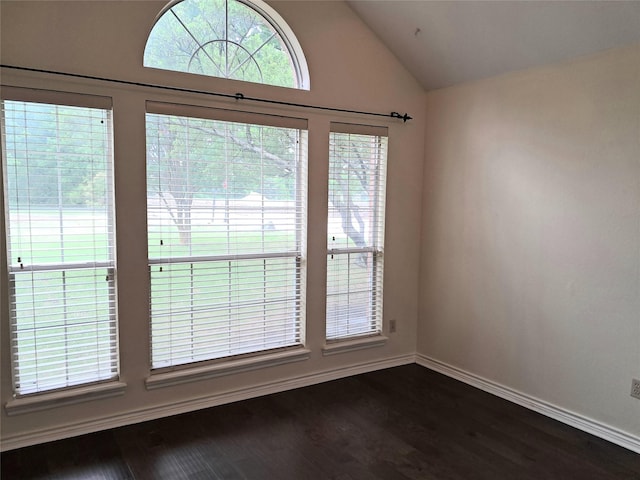 interior space with vaulted ceiling, dark wood-style floors, and baseboards