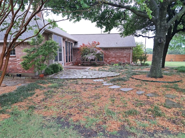 view of yard featuring fence and a patio area