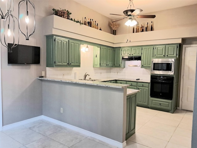 kitchen with green cabinetry, black appliances, ceiling fan, a sink, and a peninsula