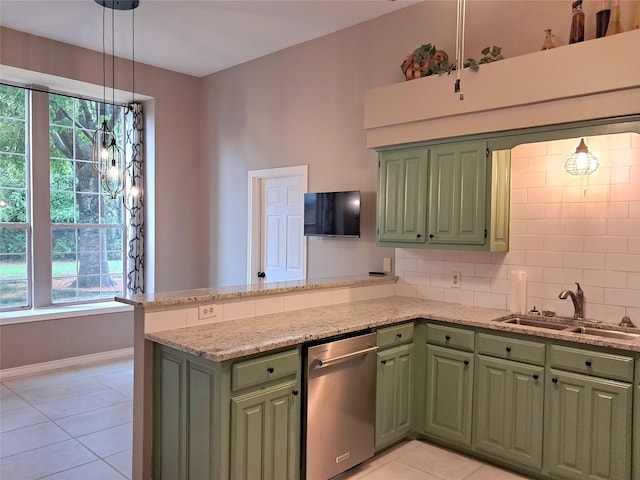 kitchen featuring green cabinetry, stainless steel dishwasher, a sink, light tile patterned flooring, and a peninsula