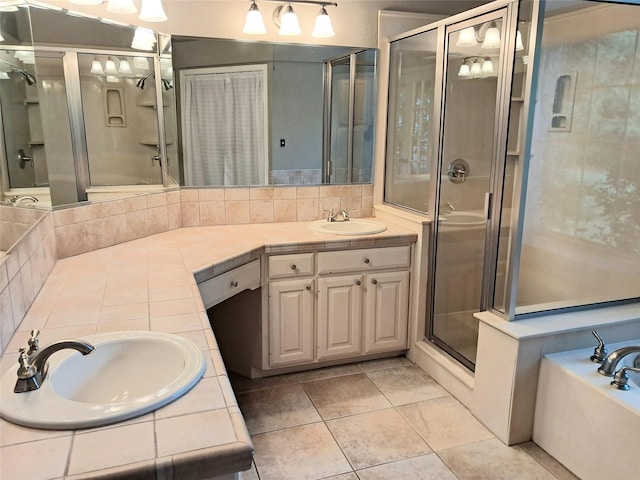 bathroom with a stall shower, tile patterned floors, a garden tub, vanity, and backsplash