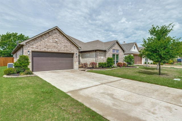 view of front of property with a front yard, concrete driveway, an attached garage, and brick siding