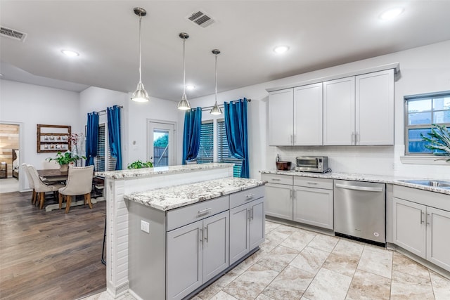 kitchen with visible vents, recessed lighting, dishwasher, gray cabinetry, and a center island