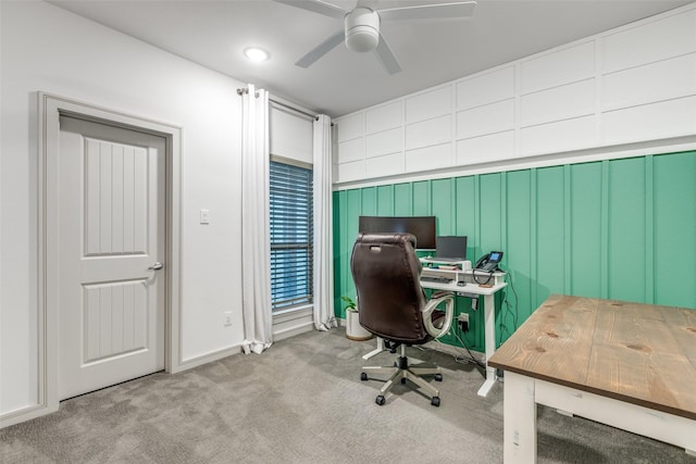 carpeted office with a ceiling fan and baseboards